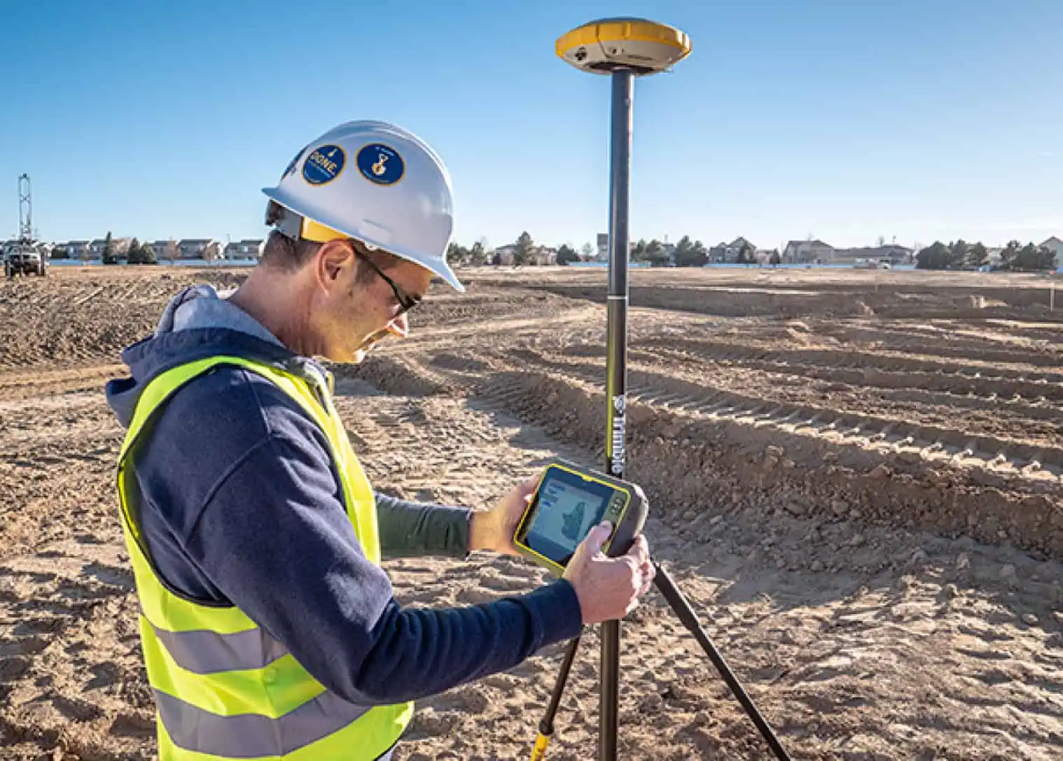 Professional Surveyor Collecting Topographical Data on Construction Site